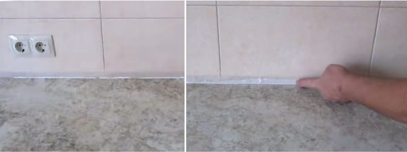 La silicona exprimida de debajo de la encimera está cubierta con un dedo.