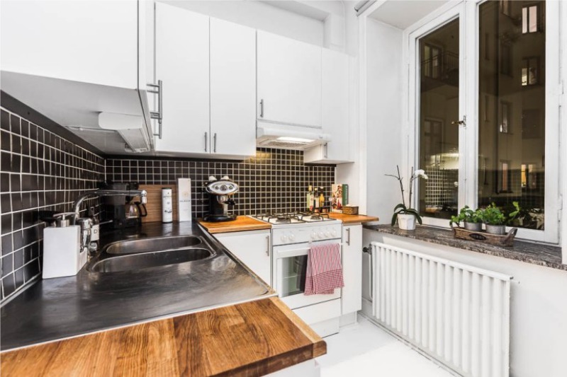 Grembiule nero all'interno della cucina bianca